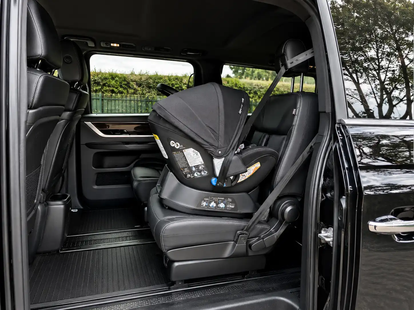Rear-facing baby seat installed for an infant in a private chauffeur car